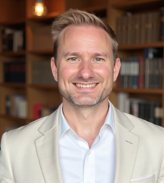 Well lit professional headshot of Martin Evans, COO of Greyhaven west, wearing a collared shirt and suit