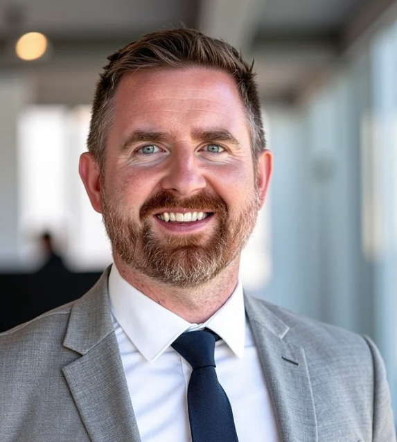 Well lit professional headshot of Andrew Dean, CEO of Greyhaven west, wearing a suit and tie