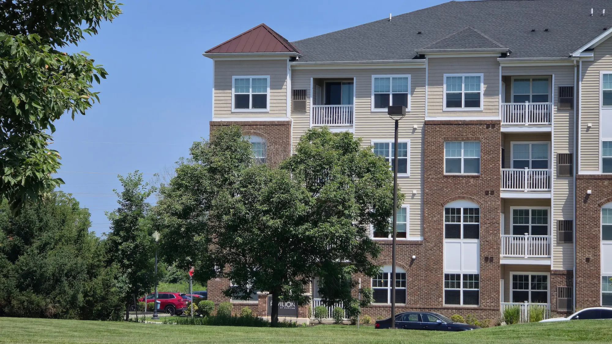 Multi-family rental property with brick and beige vinyl siding
