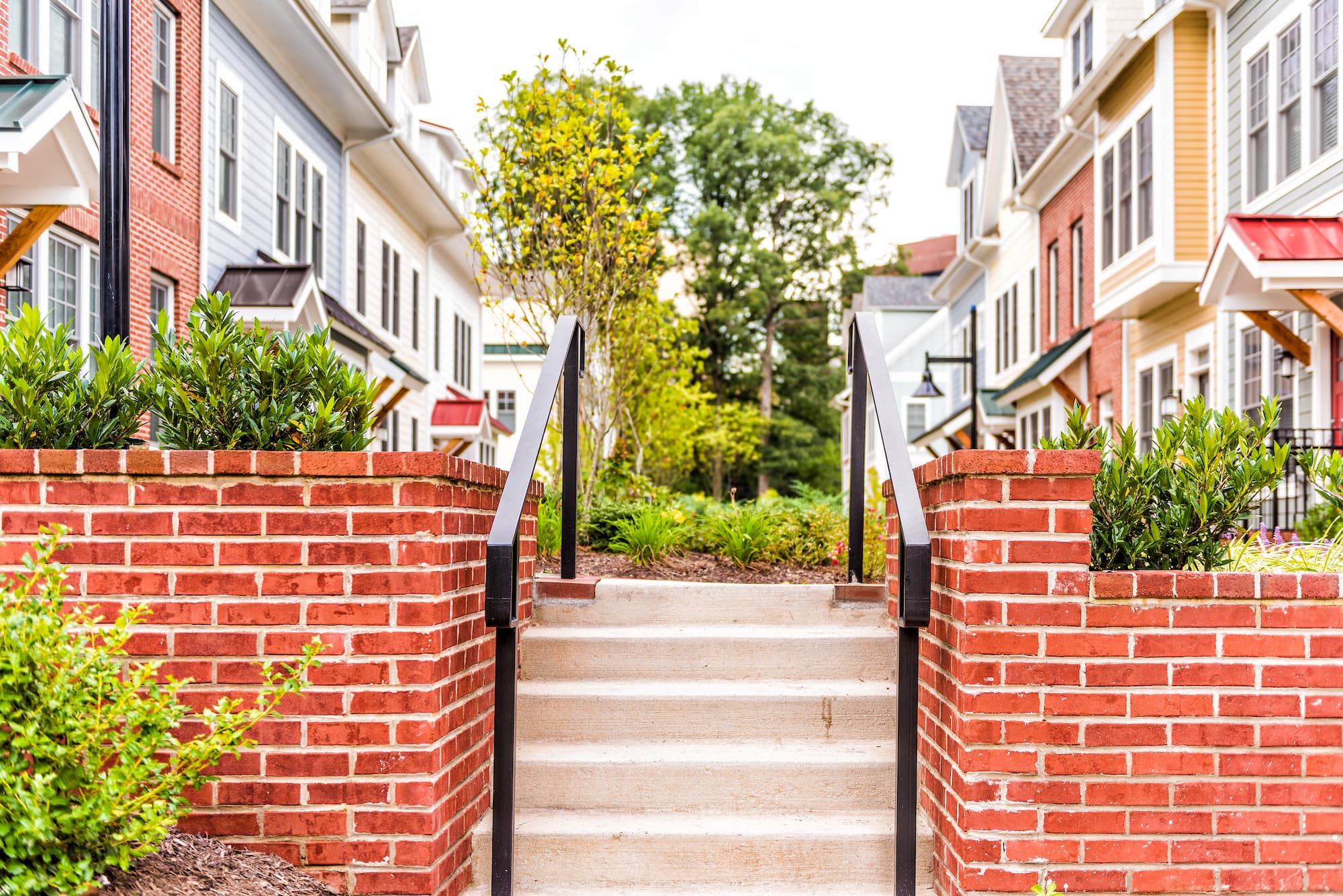 Brick staircase leading up to a courtyard surrounded by apartments